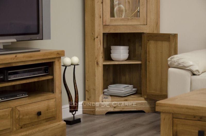 deluxe chunky rustic solid oak corner display unit with glass door to upper and two glass shelves within and one door with one shelf and choice of knobs DLXCORDU