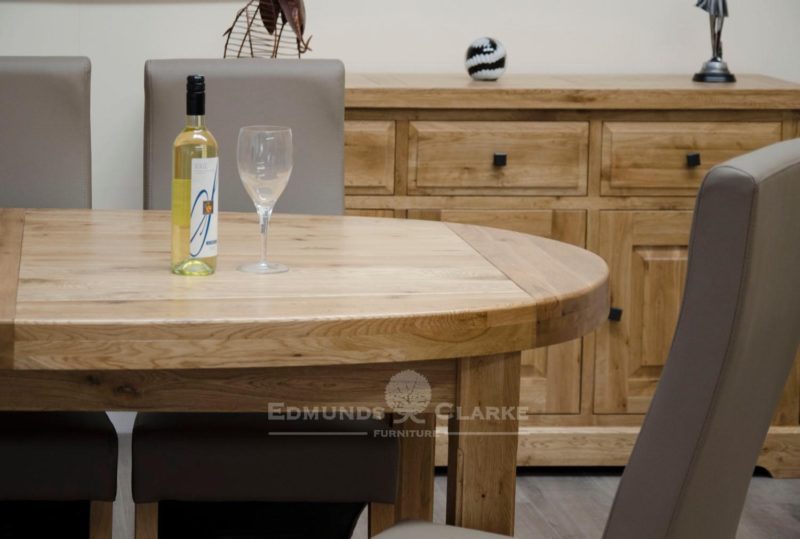 Huge super oval solid oak dining table with two stowable leaves