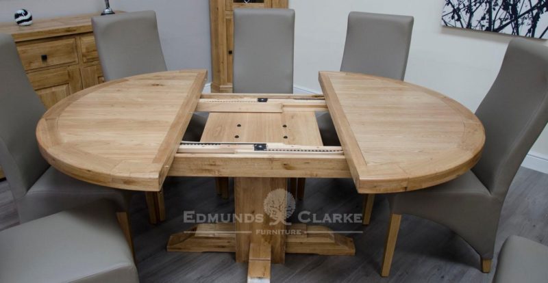 Melford solid round extending table chunky rustic solid oak 167cm centre pedestal support image showing table open showing mechanisms for opening and closing, will sit 4 to 6 people comfortably DLXRNDEXT