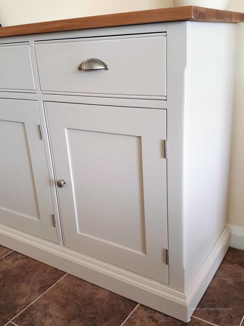 5ft Painted Sideboard handmade from Edmunds & Clarke Furniture. Painted in Dunwich stone with a solid square oak top, 3 drawers and 3 doors, image showing cup chrome cup handles and chrome knobs EDM029