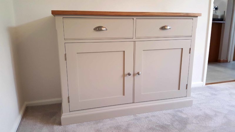 Edmunds Painted 4ft Sideboard. 25mm oak top. 2 drawers and 2 doors with adjustable shelves within. image showing dunwich stone with chrome cup handles and knobs. choice of handles. EDM040