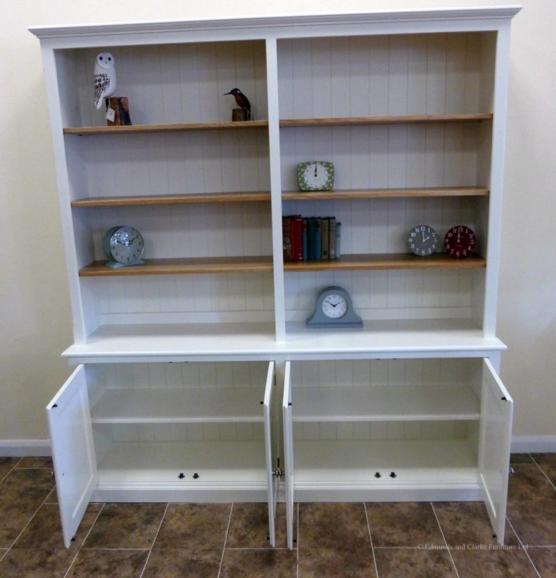 Large painted bookcase with four door cupboard below painted white with oak shelves