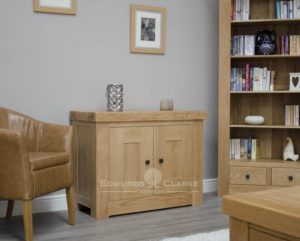 Hadleigh solid oak chunky occasional cupboard. Light lacquer with rustic square knobs. with adjustable oak shelf
