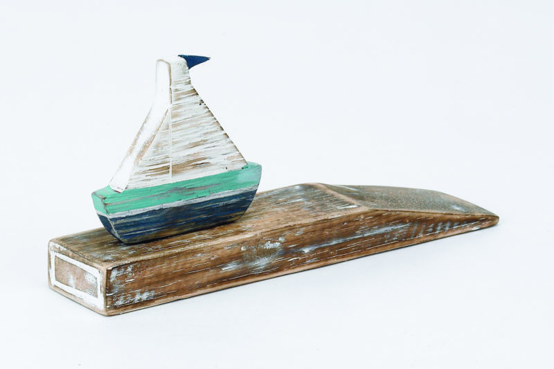 Archipelago Boat Doorstop Wood Carving D304. Blue and white sailing boat on a wedge of driftwood