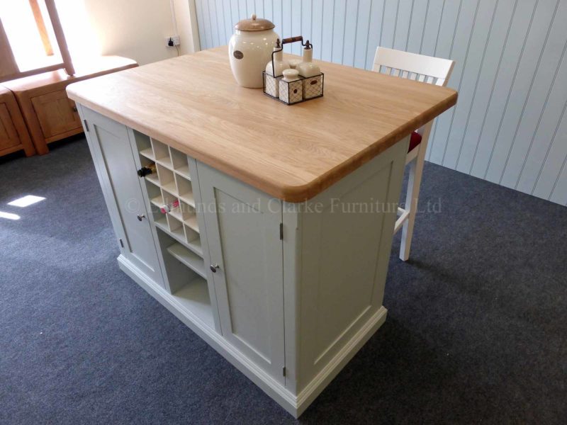 Edmunds painted 4ft x 3ft kitchen Island in Southwold Sky Blue. Solid oak top. Central shelves and wine rack with 2 paneled doors and on other side a overhang for stools. EDM008