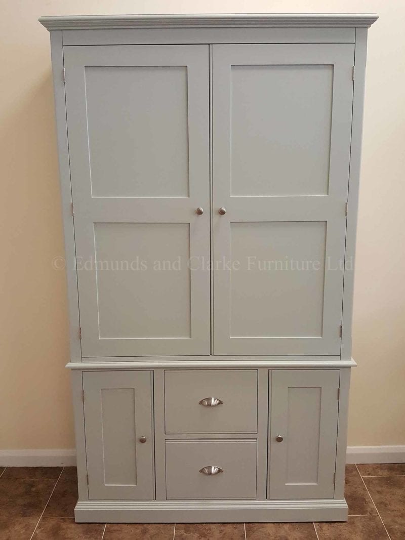 Wide two door painted larder cupboard, two large pan drawers below with door either side, made in two parts