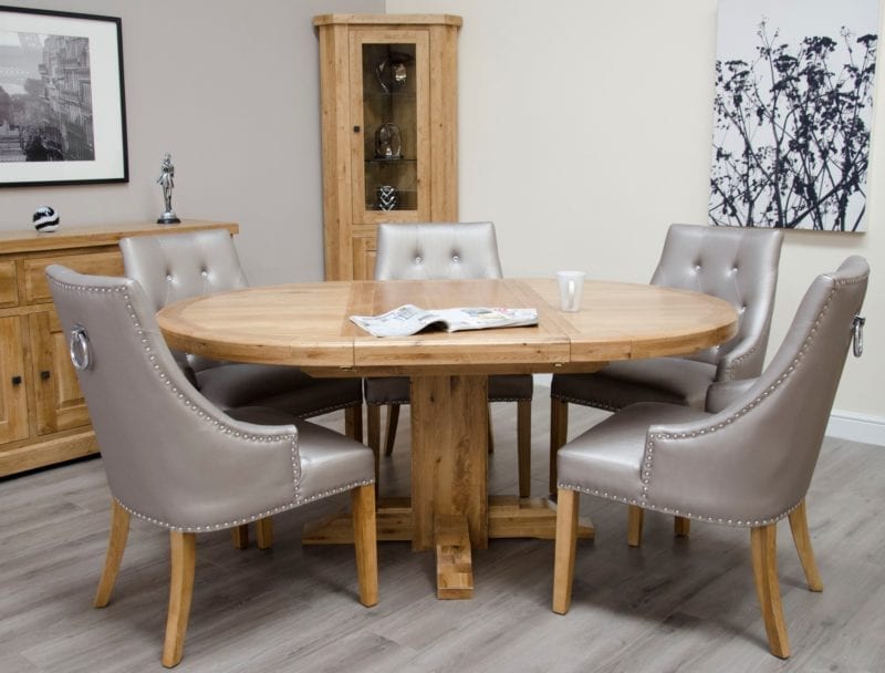 Melford Solid Oak Round Extending Dining Table. extends to a oval. image shows marjukka colour tungsten chairs