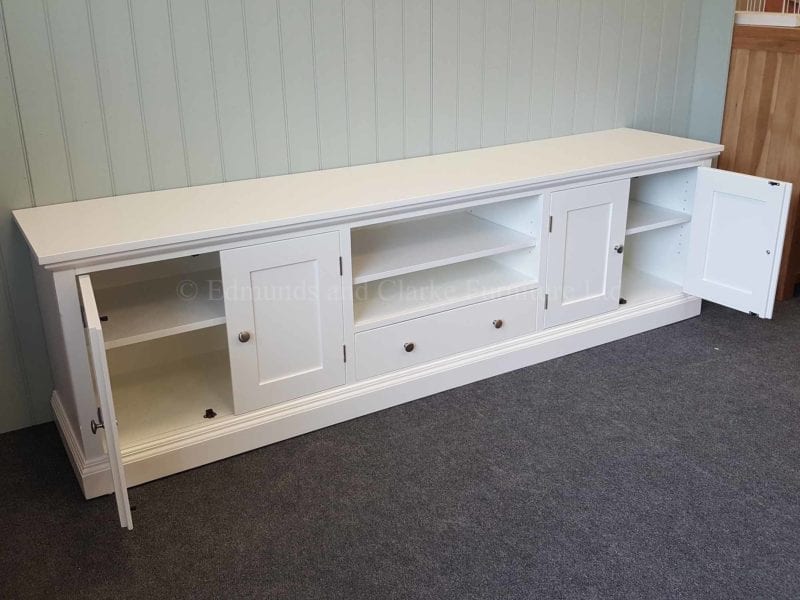 Wide TV entertainment stand painted all over white chrome knobs on four doors and central drawer