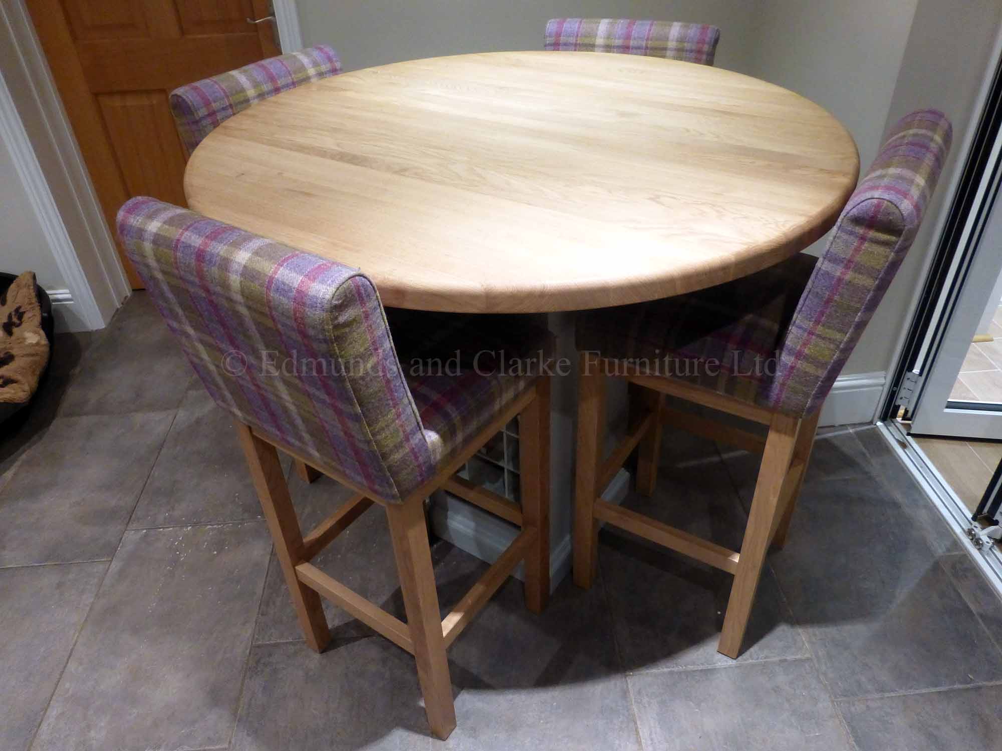 Round made to measure kitchen island with central wine rack pedestal