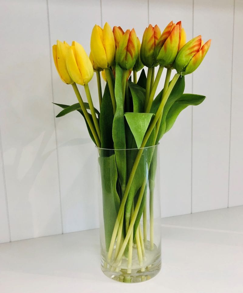 Faux tulips in glass jar