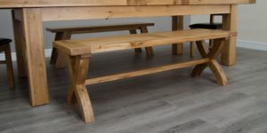 Melford solid oak bench with panelled top and cross x style legs with trestle bar