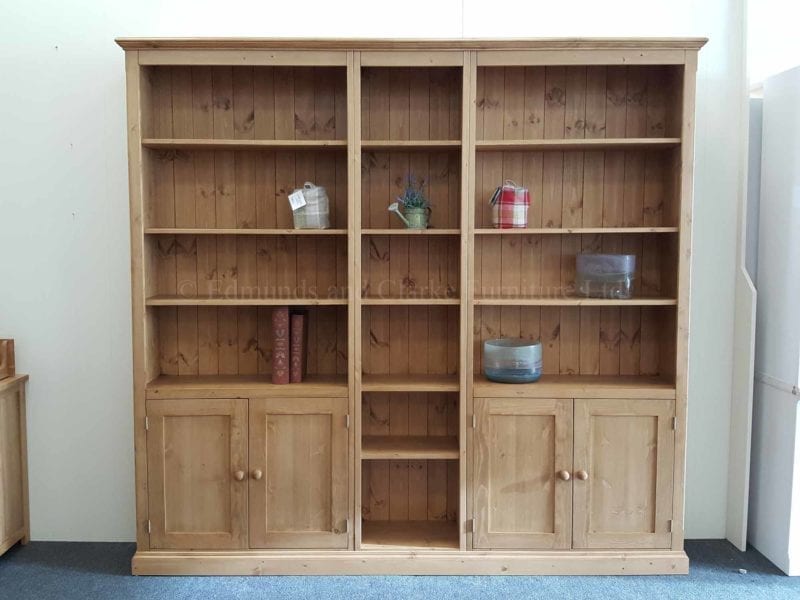 Wide three part bookcase with cupboards and open shelving 8 feet wide