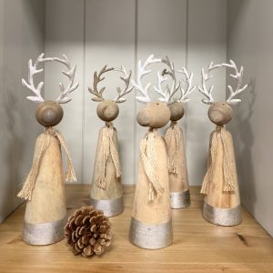 wooden and silver round reindeer Christmas decorations. Edmunds & Clarke Furniture