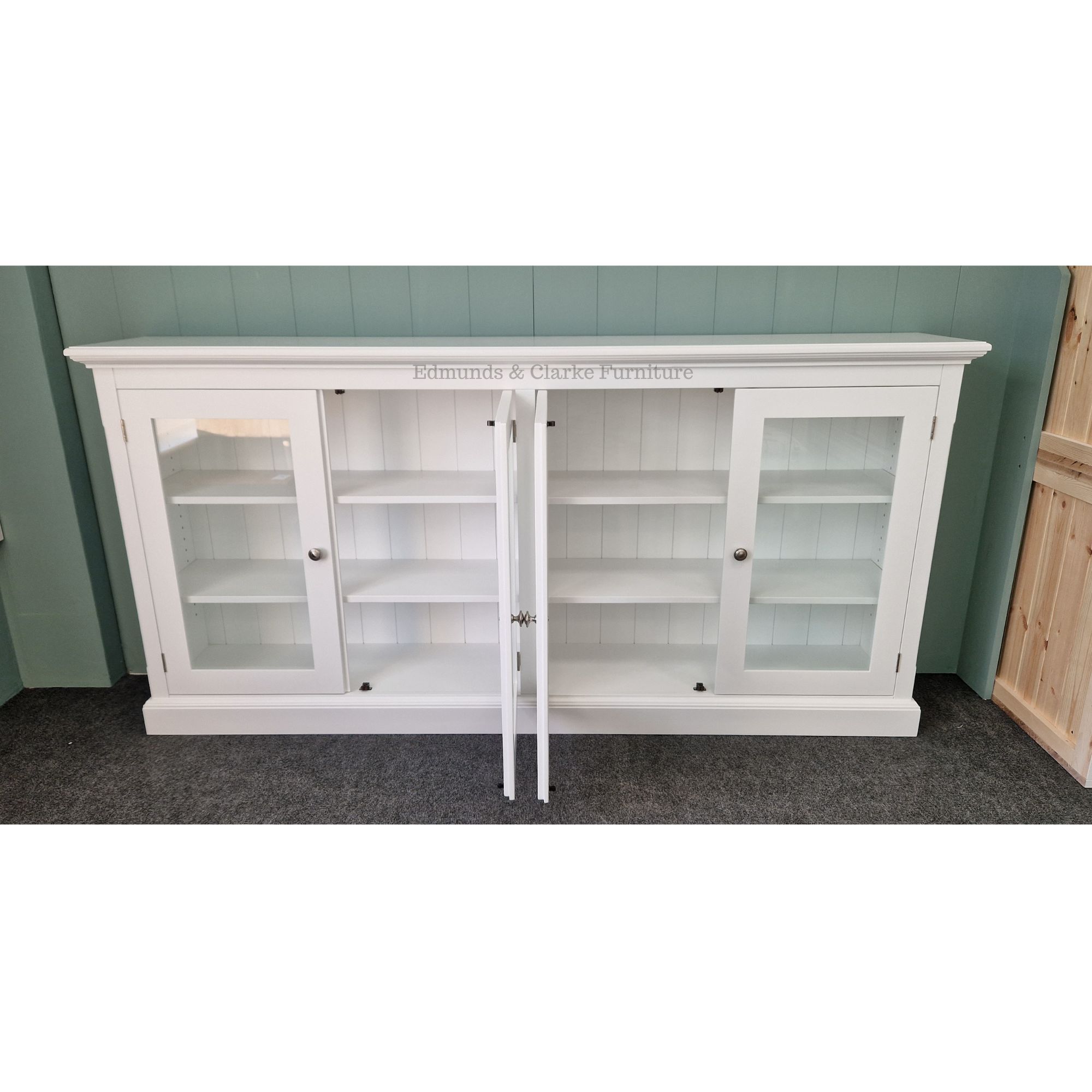 Edmunds Fully low glazed bookcase in white with doors open and painted shelves. Edmunds Clarke Furniture