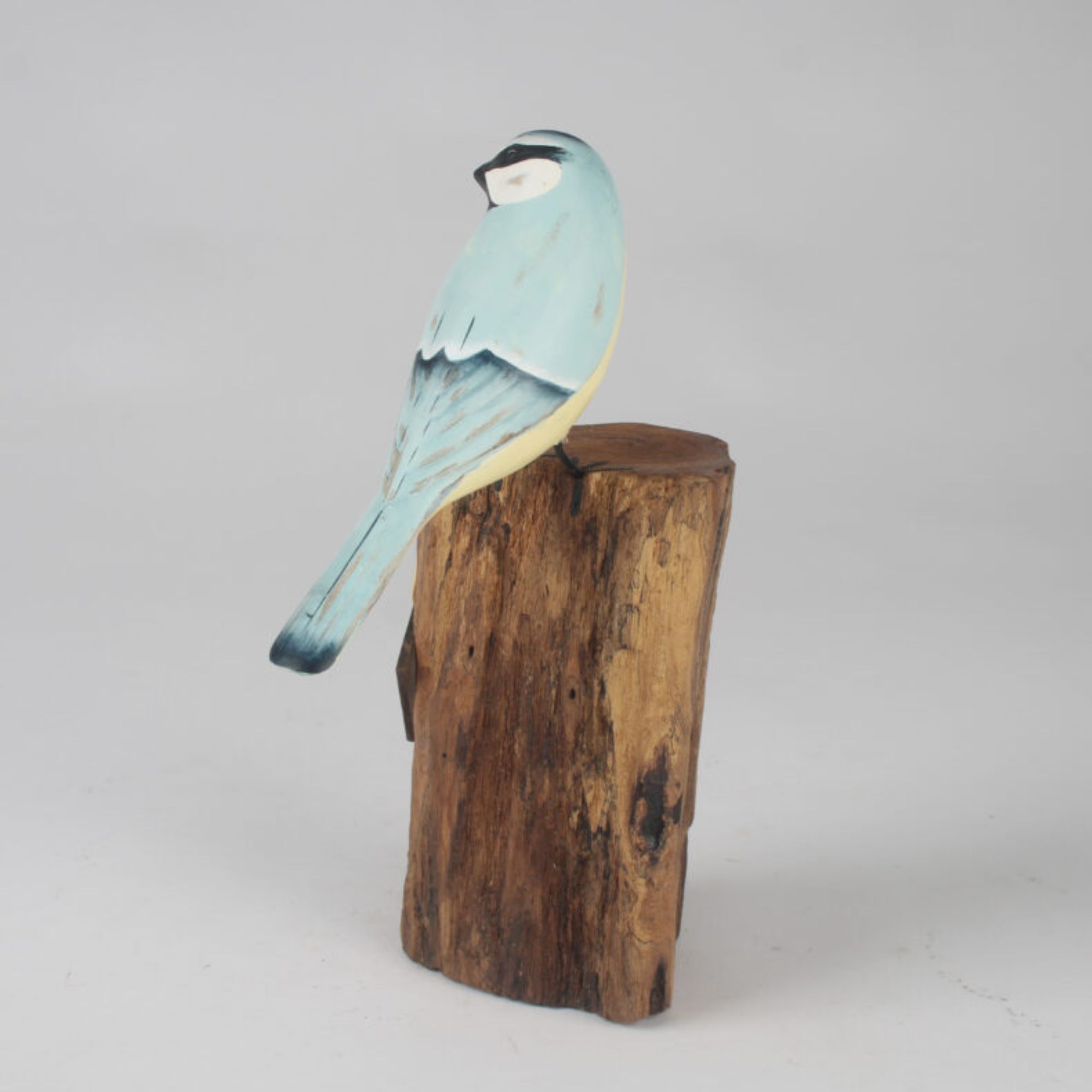 Blue Tit carving on stump side view. Edmunds Clarke Furniture