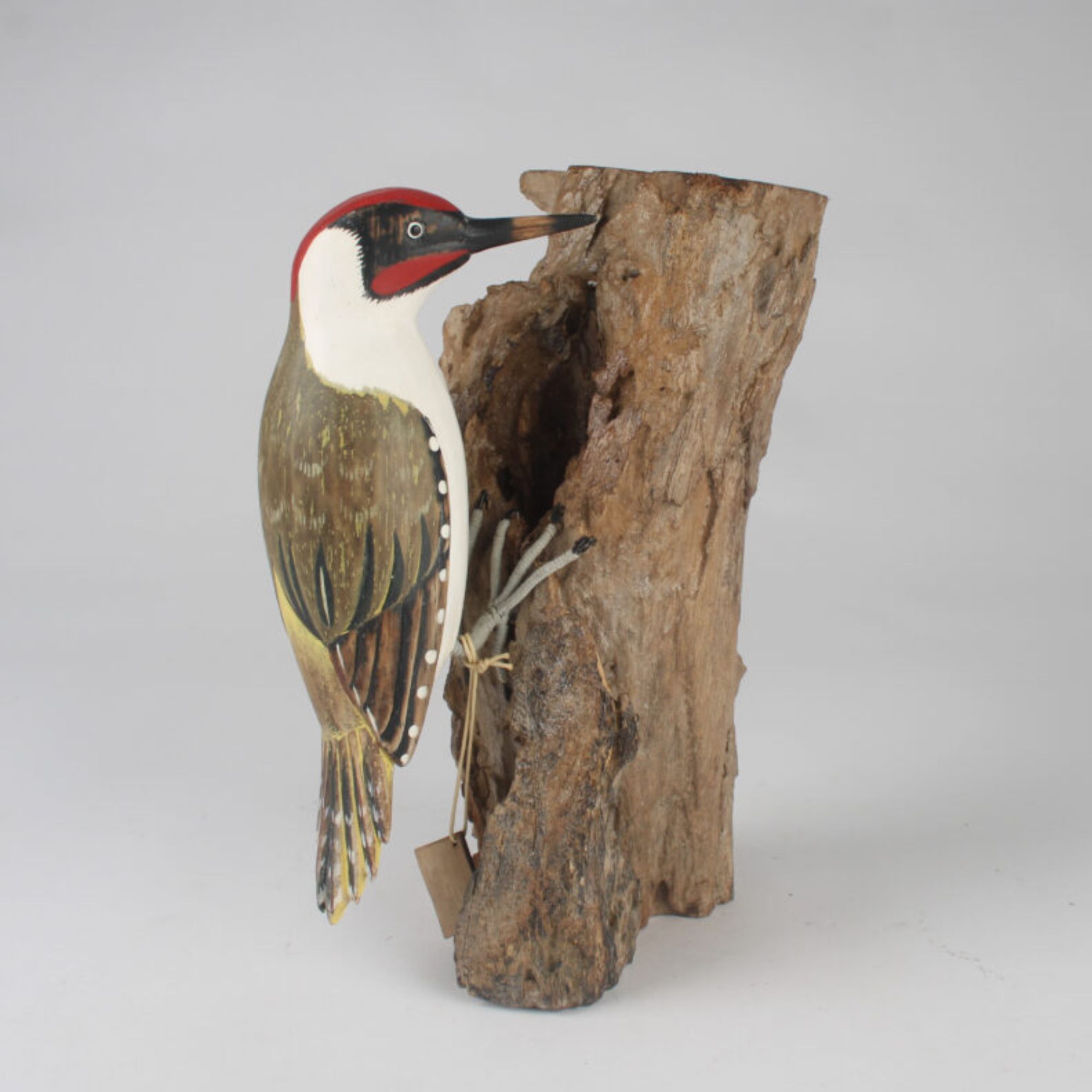 Green woodpecker wooden carving side view. Edmunds Clarke Furniture